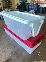 Two stacked clear plastic totes showing lids and translucency