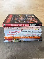 Stack of six cookbooks showing spines for title verification