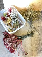 Overview of bin with mixed beaded stems and bundles of red and gold sprays