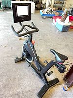 Full view of ProForm exercise bike showing frame, seat, handlebars, and touchscreen console