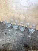 Front view of all ten clear cut-faceted small wine glasses