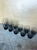 Full set of 11 smoked grey glasses, two sizes visible