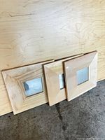 front view of three natural wood square mirrors