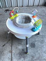 Full view of activity center showing seat and attached toys