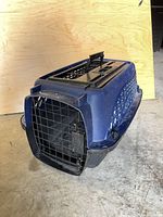 Front three-quarter view showing metal wire front door and overall wear