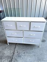 Front view showing all seven drawers and overall condition