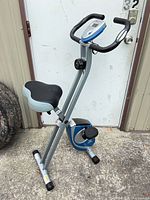 Full view of folded XTERRA exercise bike showing display, handlebars, seat and frame