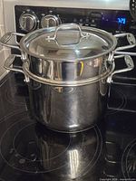 Pot with insert and lid on stovetop, front view