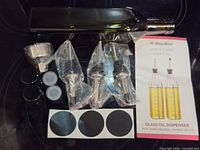 Full set: bottle, funnel, pour spouts, caps, labels, manual