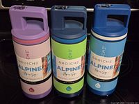 Front view of three Grosche Alpine bottles showing colors and labels