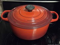 Casserole with lid on, front view showing handles and knob