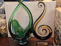 Both art glass pieces side by side showing relative size, colors, and forms