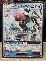 Front of Alolan Ninetales GX card showing artwork, moves, HP 210, card number 22/145 and printed signature