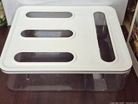 Top view of white slotted lid on clear base