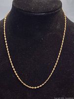 Full view of gold chain displayed on bust