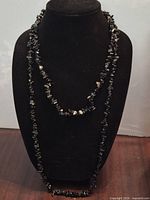 Both necklaces displayed on bust showing lengths and chip style