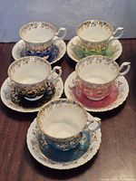 Group shot of five coloured teacup and saucer sets