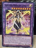 Front of Arcana Knight Joker card showing artwork, stats, set code and 1st Edition text