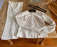 Jacket and pants laid out on table