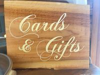 Front view of wooden sign showing script text