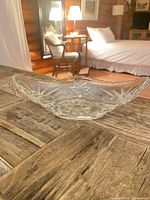 side view of oblong cut-glass dish showing scalloped rim and starburst cuts