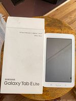 Front view of Samsung Galaxy Tab E Lite beside box