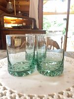 Three seafoam green tumblers standing upright