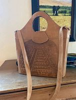 Front view showing pyramid embossing, top handle, shoulder strap