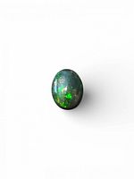 Front view of oval black opal showing green and gold fire