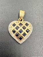 Front view of heart pendant showing lattice, sapphires, diamond border