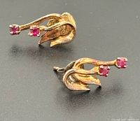 both earrings front view showing ruby settings and design