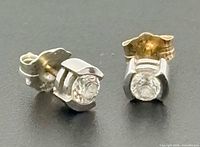 Front view of both diamond studs showing two-tone metal