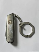 Knife with attached chain and key ring