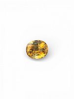 Front view of oval brilliant cut citrine, showing honey-gold color and facets