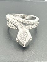 Front view of sterling silver snake ring showing head detail and stone accents