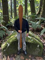 Person holding full paddle outdoors displaying overall size and design