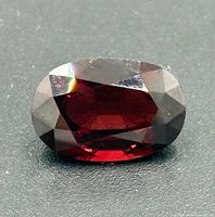 Top view of faceted oval garnet gemstone