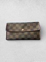 Front view showing Damier Ebene pattern and gold-tone press stud