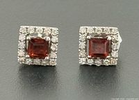 Front view of both square halo garnet earrings