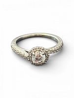 Top view showing center stone with surrounding halo and pavé shoulders