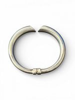 Top view of full sterling silver hinged bangle showing tubular form and open terminals