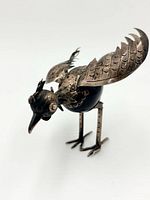 Full view of rooster figurine showing wings extended and overall form