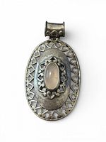 Front view of sterling silver oval pendant with rose quartz cabochon and filigree border