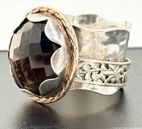 Oblique side view showing smoky quartz, bezel, band texture