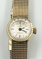 Front view showing dial, hands, faceted crystal and crown