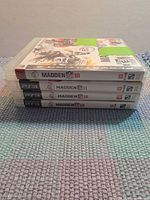Stacked spines showing Madden NFL 10-13 PS3 games