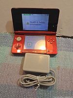 Console open, powered on with charger shown