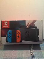 Front of Nintendo Switch retail box showing console and Joy-Con