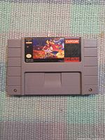 Front view of Disney's Aladdin SNES cartridge showing label and gray casing