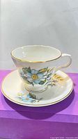 Teacup on saucer, floral motif visible